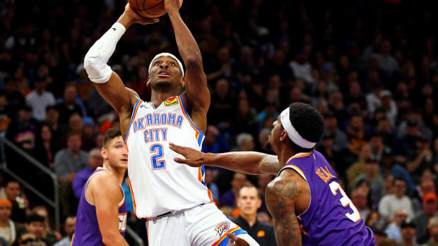 Oklahoma City Thunder guard Shai Gilgeous-Alexander (2) shoots the ball against Phoenix Suns guard Bradley Beal (3) during the first quarter at Footprint Center.